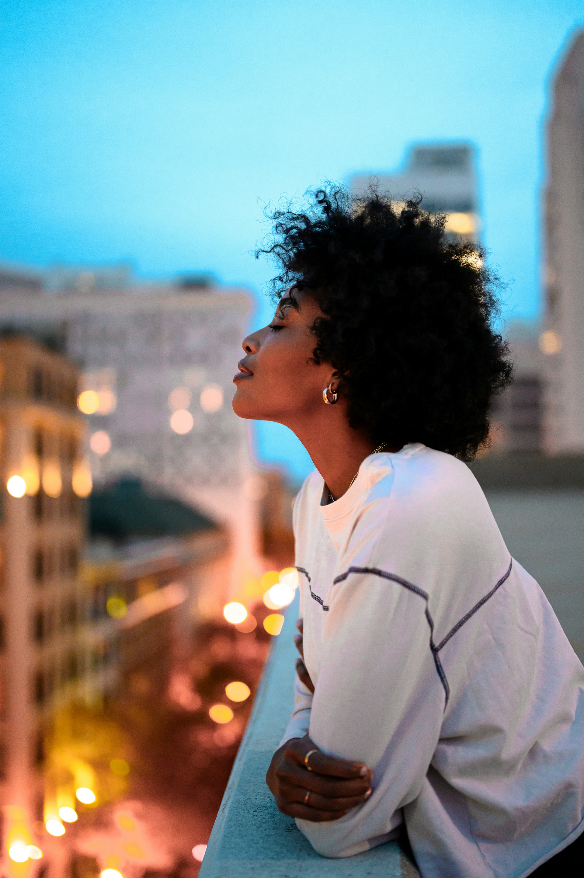 Woman overlooking the city at dusk