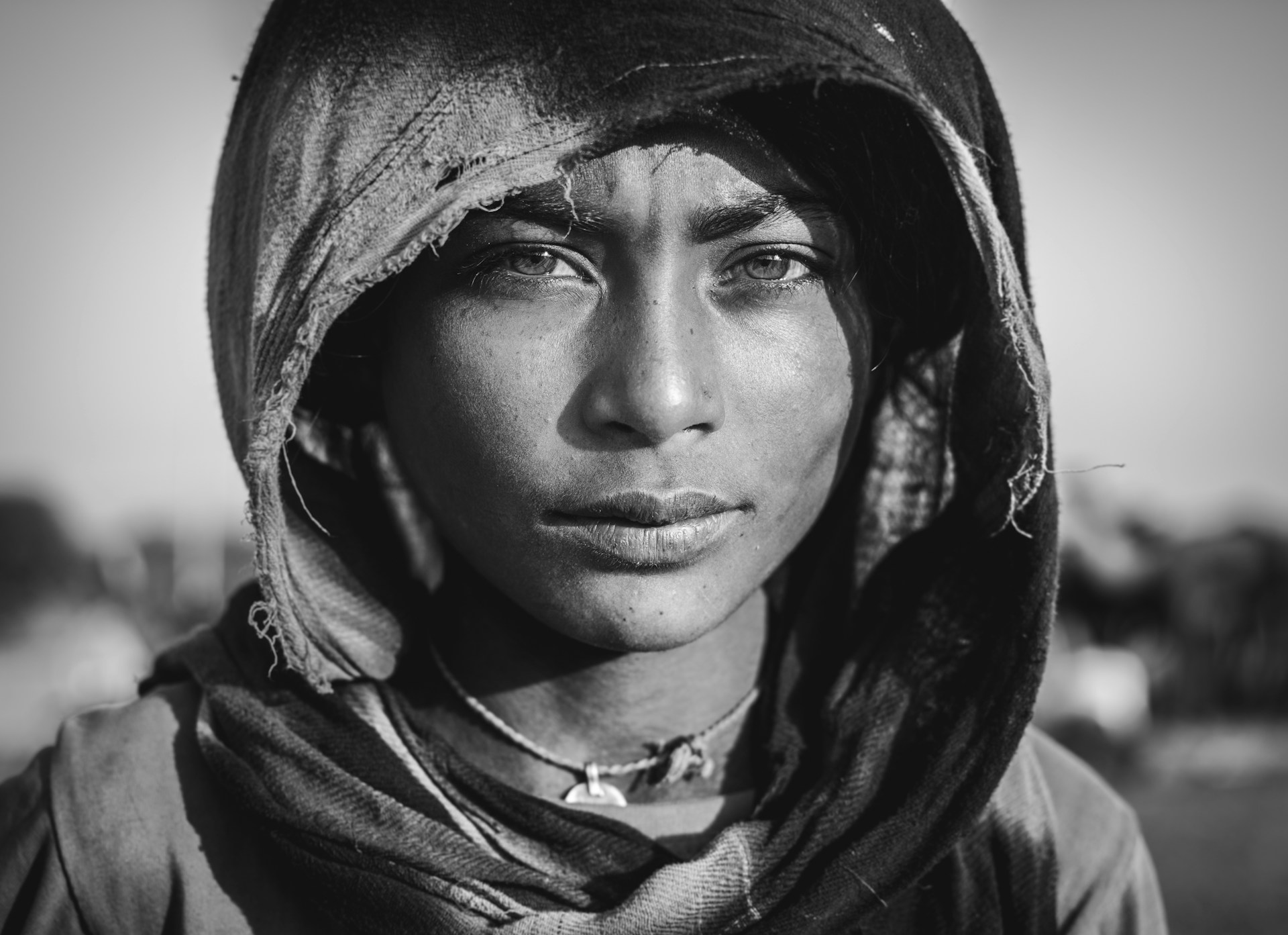 Black and white close-up portrait of a woman in a headscarf